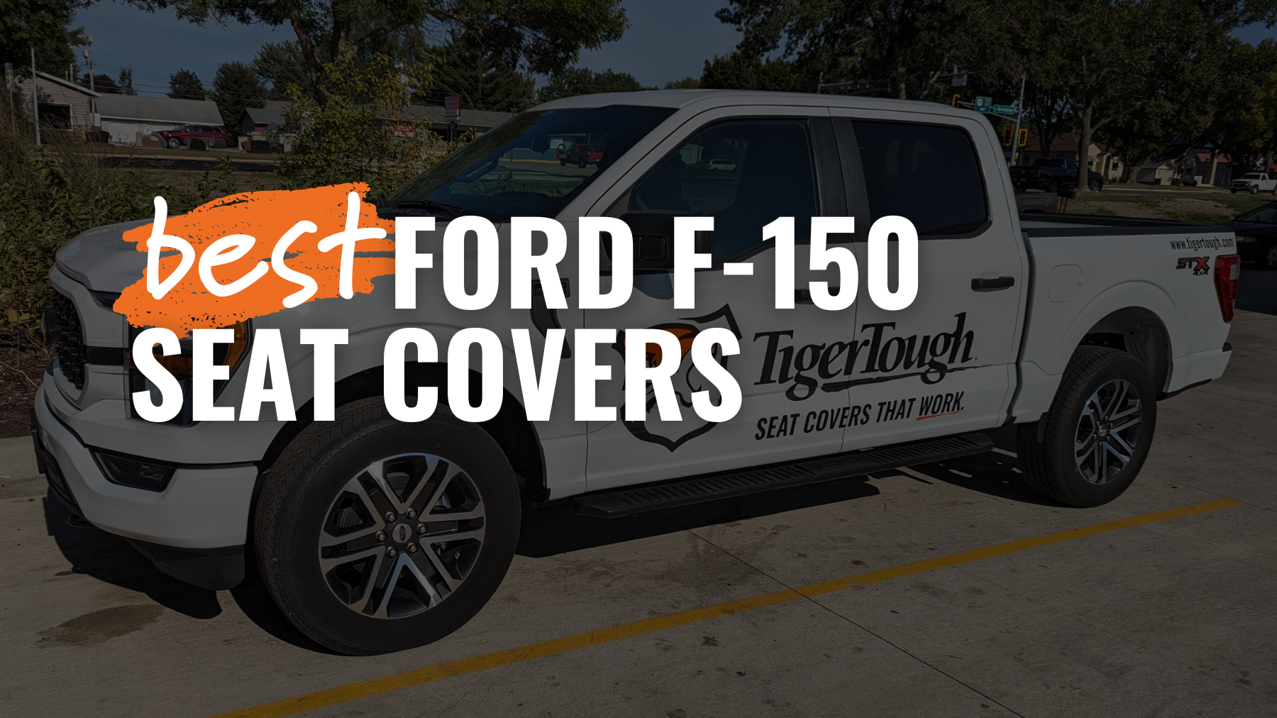 A white ford f-150 with a tigertough logo on the door and text reading: best ford f-150 seat covers