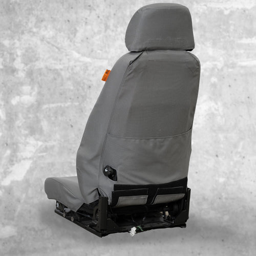 This is the back view of a TigerTough Heavy Equipment Seat Cover. You can see the built-in instruction manual pocket on the back of the cover, and it works with factory features (like the little knob on the back)