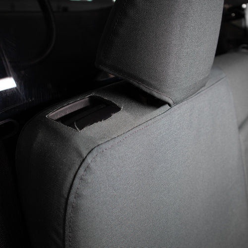TigerTough Tactical Seat Covers on the rear seat of a Tesla Model Y - Seat Latch detail